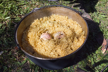 Pilau in cauldron on fire
