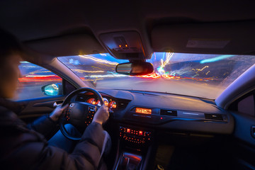 City road view from inside car natural light street and other cars is motion blurred