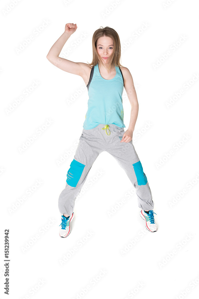 Wall mural young, pretty natural looking girl in sport t -shirt and jogging pants having fun dancing. full body