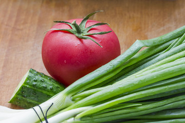 Fresh cucumber tomatoes cucumber and green onions close