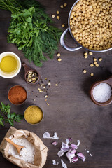 Cooking ingredients, chickpeas  with spices on wooden board,