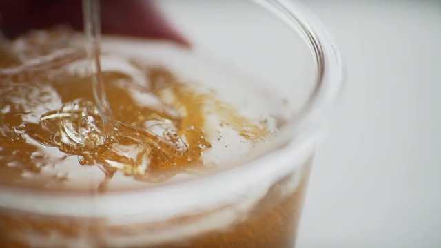 Cosmetician takes the sugar paste from the jar. Shugaring