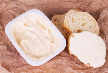 bread with melted cream cheese On brown paper