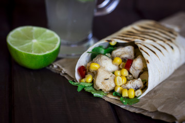 Homemade fajita with cocktail and lime on the wooden dark table