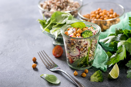 Fototapeta Quinoa salad with chickpeas in mason jar, spinach, veggies, healthy vegan food, dieting, clean eating, vitamin and protein snack