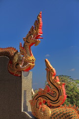 Fototapeta na wymiar Naga's head and tail with blue sky in the temple, Thailand