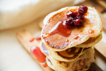 Blueberry pancakes on a contrasting black background. Close up