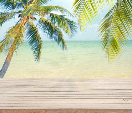 Empty wooden with coconut tree and sea background for product display.(Shadow coconut on wooden)