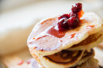 Blueberry pancakes on a contrasting black background. Close up