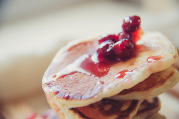 Blueberry pancakes on a contrasting black background. Close up