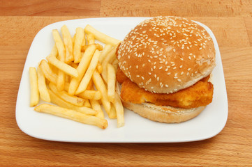 Fish burger and fries on a table