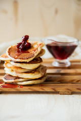 Stack of pancakes with jam and sugar