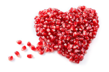 Pomegranate. Fresh raw seeds isolated on white background. Heart shape.