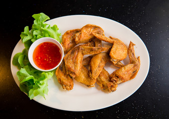 Fried chicken wings on white dish, Thai food