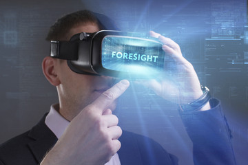 Business, Technology, Internet and network concept. Young businessman working in virtual reality glasses sees the inscription: Foresight