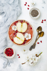Healthy breakfast set. Acai superfoods smoothies bowl with chia seeds,  pomegranate, sliced apples and honey. Overhead, top view, flat lay, copy space. Traditional food of jewish  Rosh Hashana.