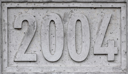 Concrete block with the year 2004 engraved