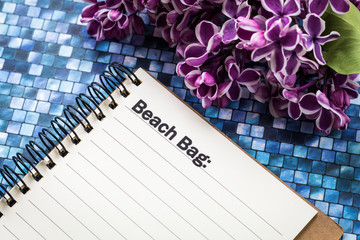 Naklejka premium Beach Bag list concept on notebook and purple lilac