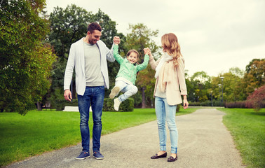 Naklejka na ściany i meble happy family walking in summer park and having fun