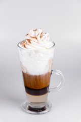 Latte with whipped cream on isolated white background