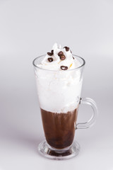 Latte with whipped cream and coffee beans on isolated white background