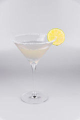 Martini glass with lemon on isolated white background