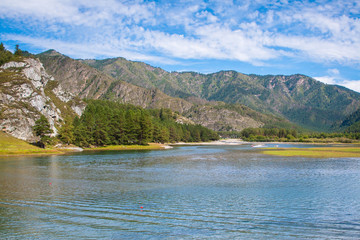 A beautiful lake with mountains in the background. The magnificent mountain landscape in Sunny weather.