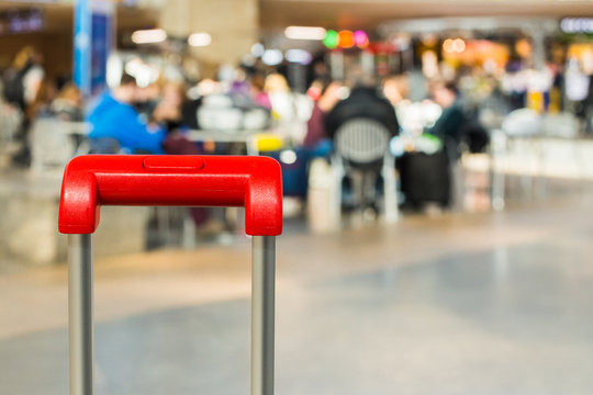 Red suitcase handle close up