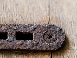 nut and rusted iron stuck on wood.