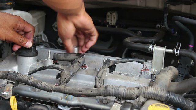 Auto Mechanic Repairing A Car Engine