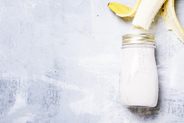 Banana smoothies in a bottle, top view, flat lay