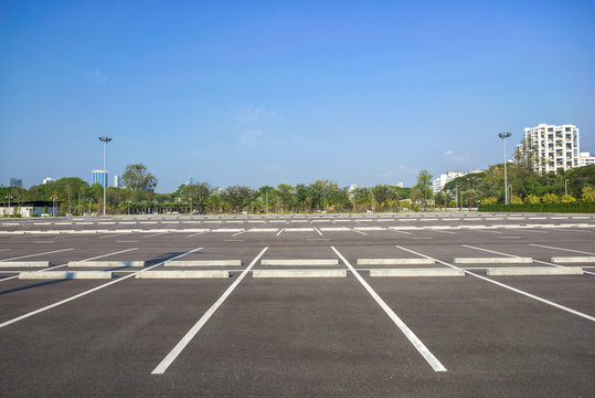 Empty parking lot at city center with blue sky