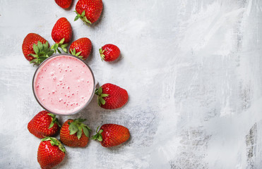 Strawberry milkshake with berries, food background, top view