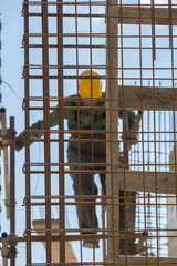 Worker fabricating steel reinforcement bar at the construction site
