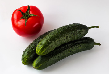 Fresh vegetables, tomatoes and cucumbers on a white background. Vegan