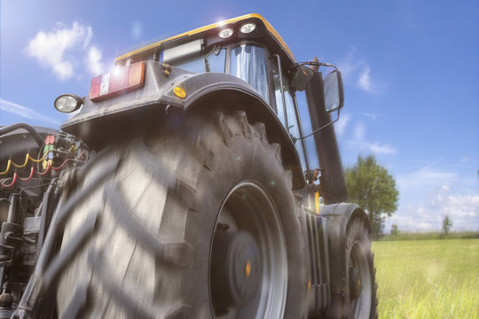 a tractor speeding on a meadow