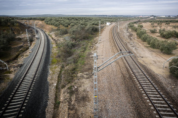 train rails with a city at the background, Jaén, Spain