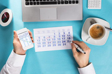 Businessman Marking Schedule On Calendar Using Gantt Chart