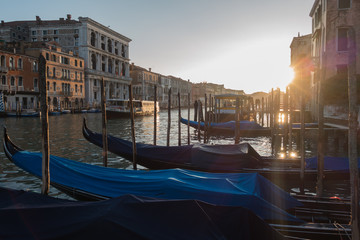 Sunset time over gondolas in Canal Grande, Venice, Italy