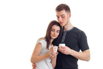 a charming young couple holding a warm cup of tea