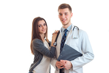 beautiful smiling girl put her hand on the shoulder of a young doctor in a white lab coat