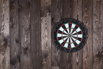 Dart board on a wooden wall