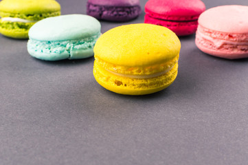Colourful french macaroons on the grey background