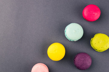 Colourful french macaroons on the grey background, Top view