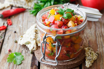 Tomato salsa with chili in a glass jar