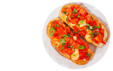 Italian tomato bruschetta with chopped vegetables, herbs, cheese and oil on grilled or toasted crusty ciabatta bread. top view. isolated on white