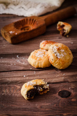 Maamoul or mamoul - arabic cookies stuffed dates with coconut near wooden mold on vintage wooden table background. Selective focus. Toned image