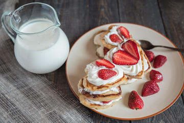 pancake in the shape of a heart with strawberries