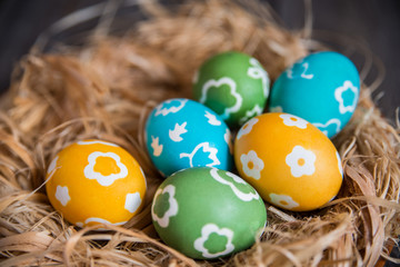 Fototapeta na wymiar colorful eggs in a wicker nest