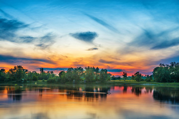 Naklejka premium Beautiful sunset above a big river